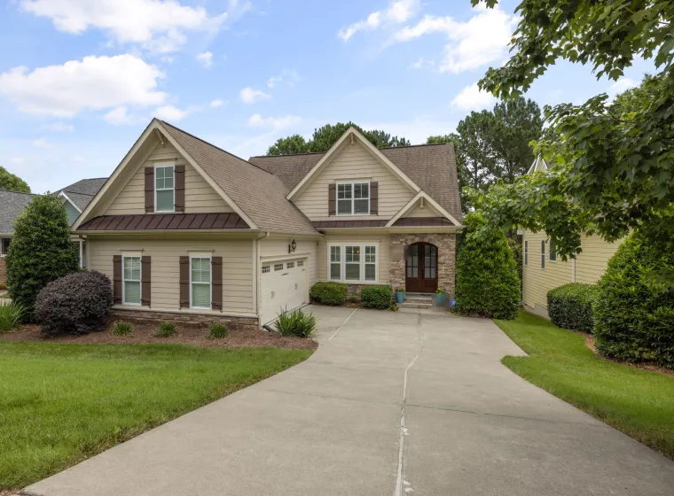 Two-story family home with a two-car garage and a front lawn